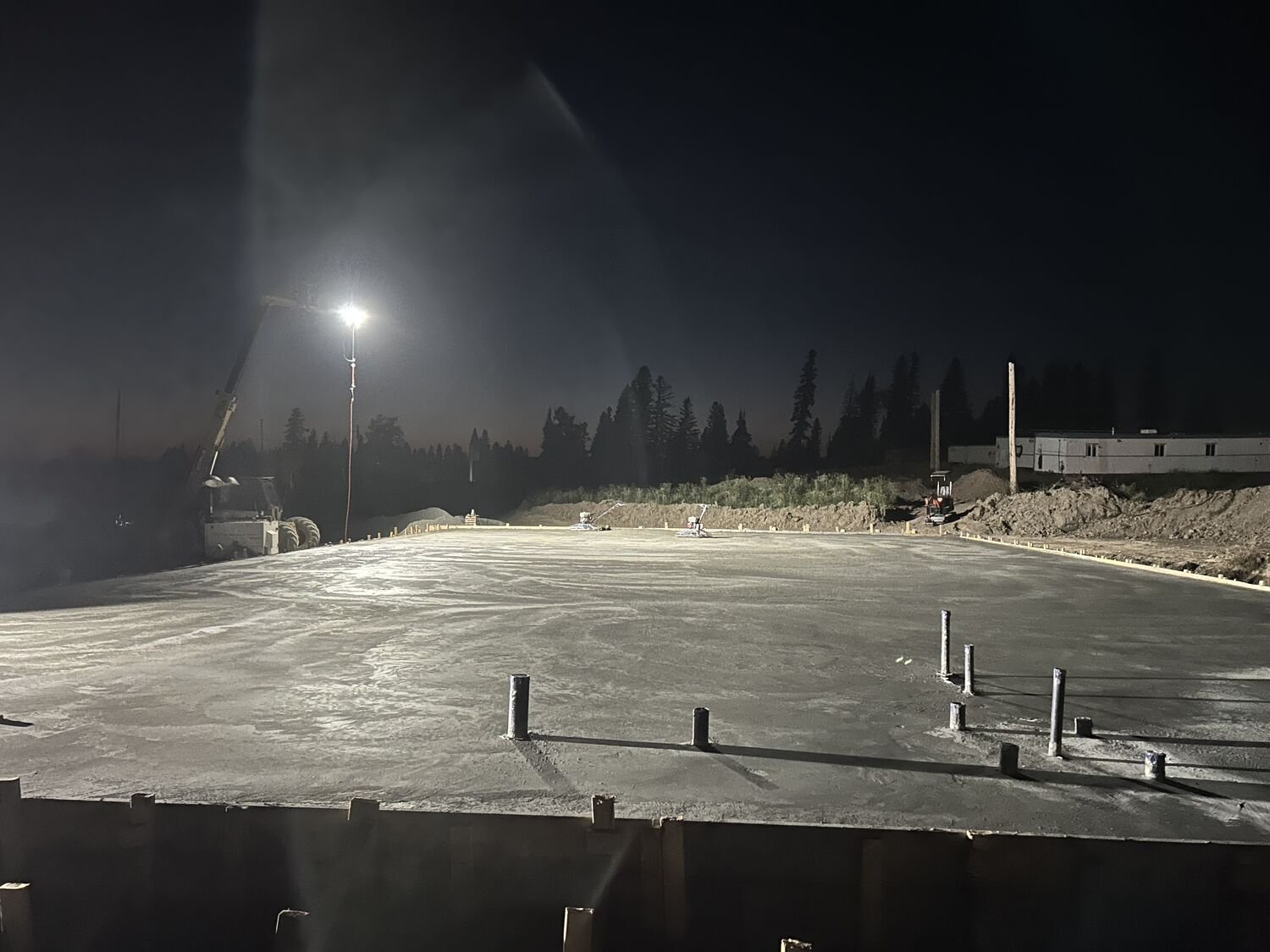Concrete pour on a northern site at night under work lights.
