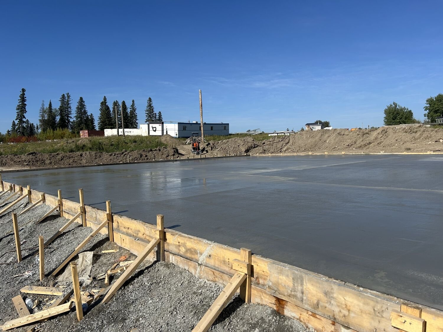 Foundation forms and site servicing at a northern build.
