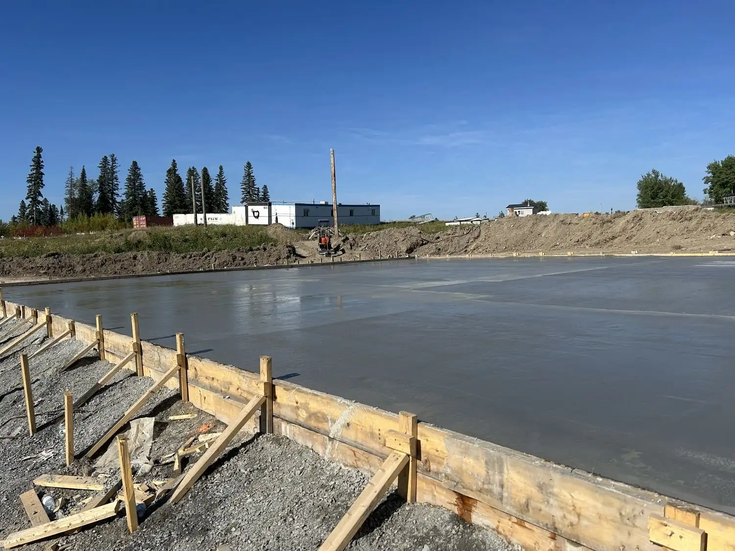 Foundation forms and site servicing at a northern build.