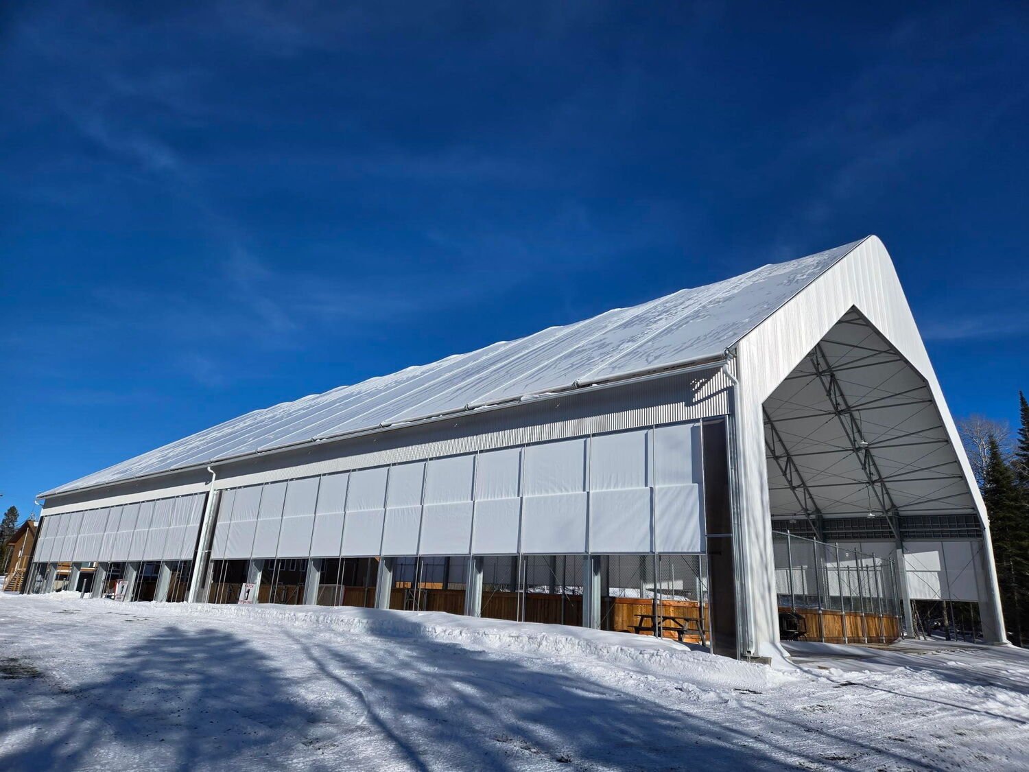 Kaebe community building project under a clear northern winter sky.